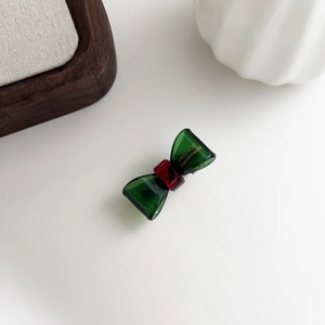 Detailed macro view of the bow-shaped acetate hair clip with gold France Handmade lettering