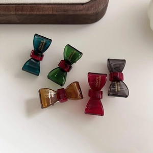 Detailed set of five translucent acetate bow hair clips in assorted retro vintage colors
