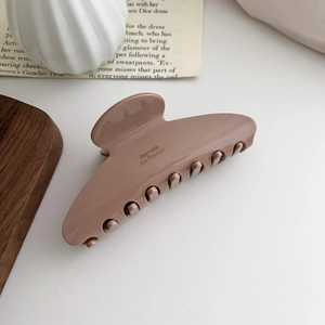 Detailed close-up of large milk tea acetate hair claw with golden Barrette La France text