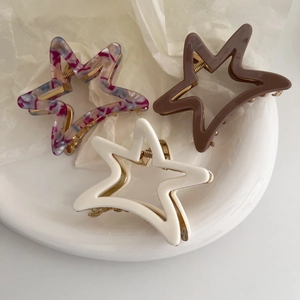 Three-piece set of hollow star-shaped acetate hair claws in marble purple, brown, and white