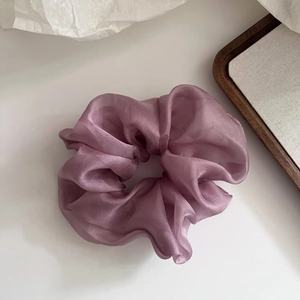 Macro detail of lavender lilac tulle scrunchie with soft translucent pleated texture