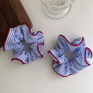 Elegant blue and white striped scrunchies set with red piping on a clean white background