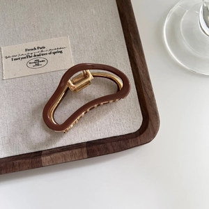 Elegant coffee brown and gold metal hair claw clip with a minimalist cloud design