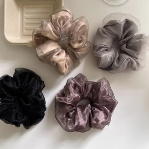 Set of four layered mesh and satin scrunchies in champagne, silver, black, and purple