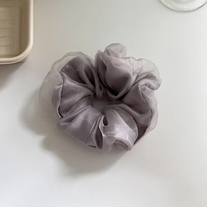 Minimalist smoky grey double-layered organza scrunchie with elegant pleated fabric texture
