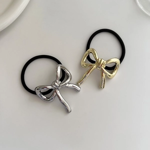Close-up of gold and silver metallic bow hair ties with high-elastic black rubber bands