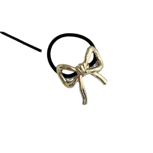 Minimalist gold bow pendant hair tie with black high-elastic rubber band on white base