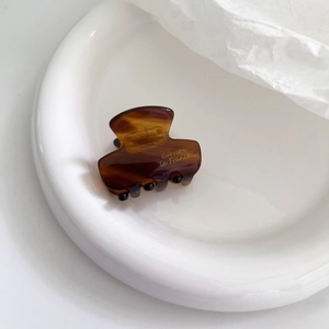 Mini marble acetate hair claw with brown tortoiseshell pattern and gold lettering