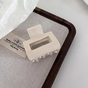 Minimalist cream rectangle acetate claw clip for women on elegant wooden tray