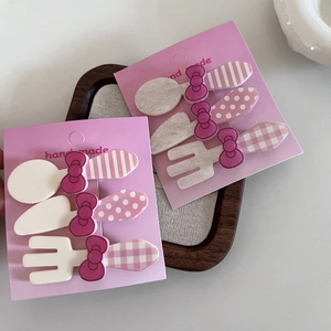 Set of 3 pink bow hair clips featuring cute cartoon cutlery shapes on display cards