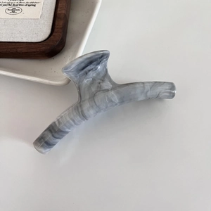 Elegant grey marble ink hair claw clip for women stylish hair accessories on desk