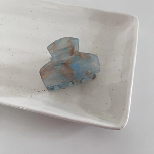 Detail of starry blue and brown acetate hair claw clip with fine shimmering glitter