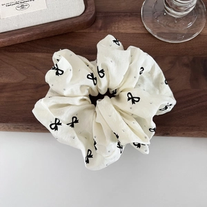 Elegant off-white scrunchie with black bow prints and sparkling rhinestones hair accessory
