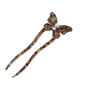 Elegant tortoiseshell butterfly hair stick with white pearls in a classic U-shape design