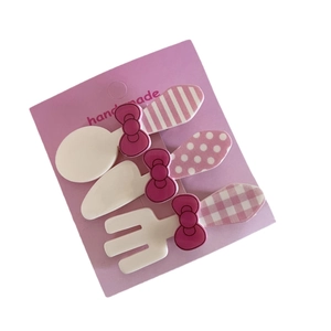 Set of 3 pink cartoon cutlery hair clips with bows and patterned handles on card