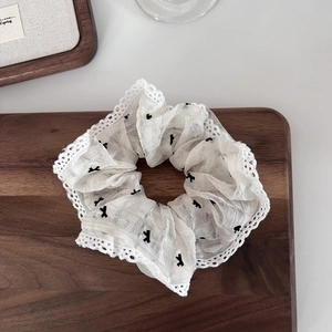 Summer white lace scrunchie with black embroidery bows and elegant wavy texture
