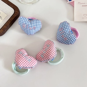 Detail of embroidered heart checkered hair ties in pink and blue plaid fabrics