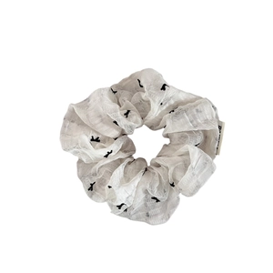 White lace scrunchie with black bird print and woven label for summer hairstyles
