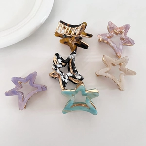 Set of 6 small acetate star hair claw clips in marble and tortoiseshell patterns