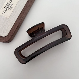 Detailed view of large dark brown translucent rectangular hair claw clip with glossy finish