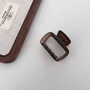Detail of a large 13cm translucent amber acetate hair claw clip with sturdy metal spring