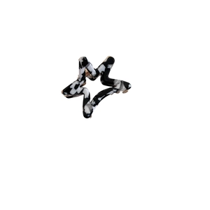 Star-shaped acetate hair claw clip with black and white marble pattern for women