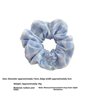 Close-up of blue plaid cotton linen scrunchie with embroidery, size 14cm diameter
