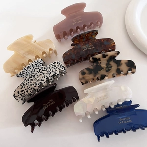Set of 8 French acetate claw clips in assorted colors and patterns for elegant hair styling