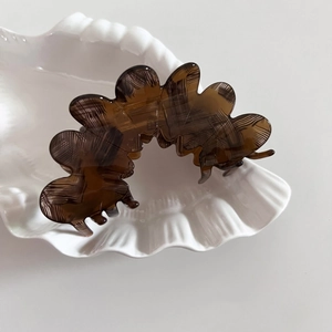 Elegant dark brown acetate flower petal hair claw clip with a glossy amber texture finish