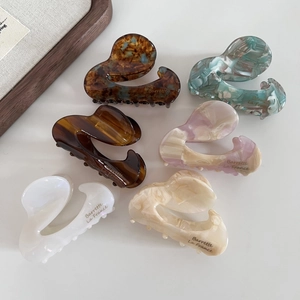 Detailed close-up of 6pcs assorted acetate hair claws with elegant S-shaped marble patterns