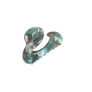 Elegant marble mint green acetate hair claw clip with golden French lettering on white background