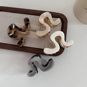 Elegant wave shaped acetate hair claws in tortoise and pearl white for women