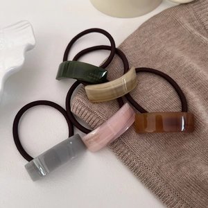Detailed set of five acetate marble hair ties with France Handmade text in warm setting
