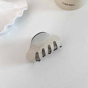 Minimalist cream wavy hair claw clip with black border and sleek acetate finish