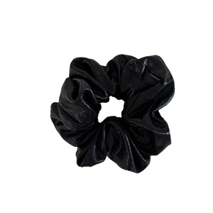 Metallic black scrunchie hair tie with shimmering fabric texture for elegant ponytails
