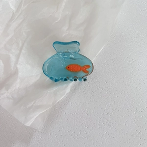 Translucent blue hair claw clip with orange fish and bubble details in resin material