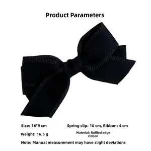 Detail view of 16x9cm black bow hair clip with textured ribbon and 10cm spring clip