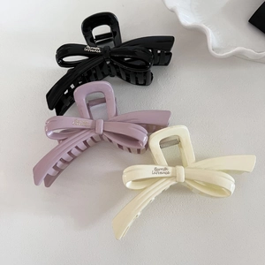 Three elegant bow claw clips in black, lavender, and cream white for thick hair styling