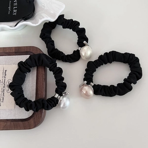 Three-piece set of black scrunchies with elegant pearls and silver metal hardware