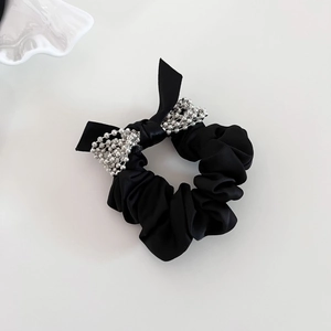 Elegant black satin scrunchie with silver bead bow detail on a clean white background