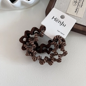 Close-up of high-elastic spiral hair ties in brown zebra pattern on display card