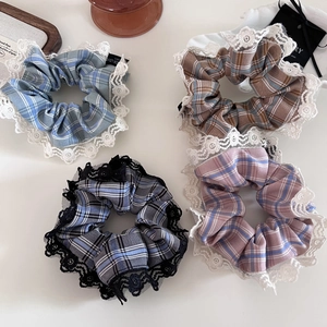 Close-up of vintage plaid scrunchies with lace trim in four soft pastel color palettes