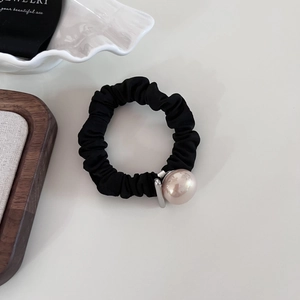 Elegant black scrunchie with a large pink pearl accent and elastic fabric for women