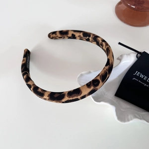 Detail shot of a handmade leopard print fabric headband with high-quality stitching