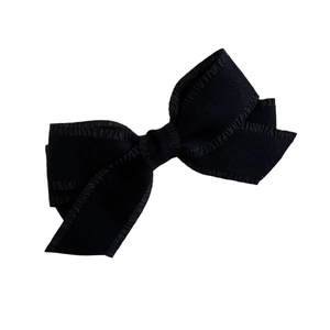 Elegant Korean style black textured bow hair clip with vertical ribbing on white background