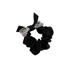 Elegant black scrunchie with a silver beaded bow detail for chic ponytail styling