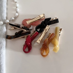 Handmade twisted resin hair clips in various colors with elegant gold metal clips