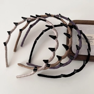 Wavy fabric wrapped headbands set in beige, brown, purple and black with stud details