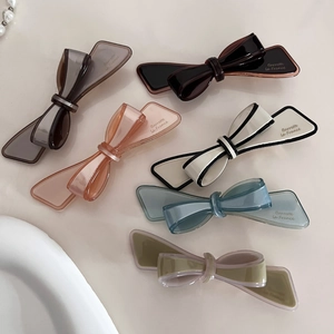 French bow hair clips in six translucent colors with Barrette la France logo lettering