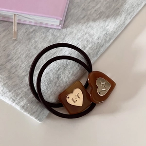 Elastic hair ties with geometric heart resin charms and engraved gold metal detail